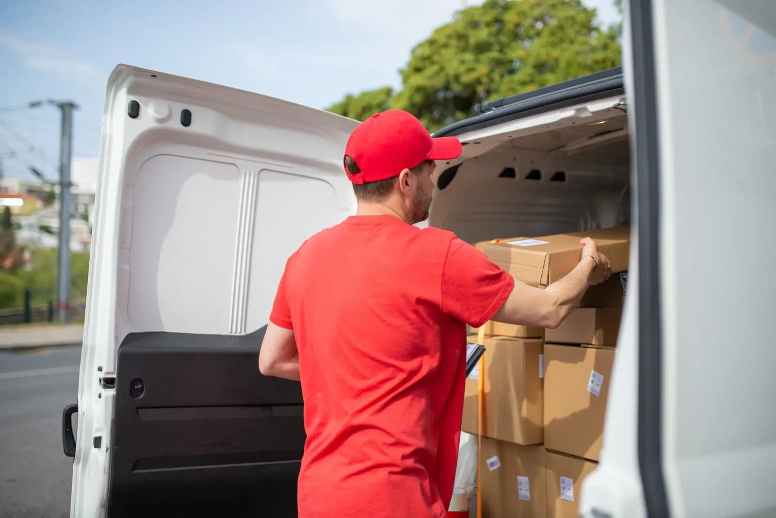 A man loading boxes into a car